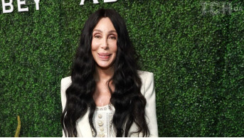 Cher takes the West Hollywood party by storm with flared jeans and a pearl corset top